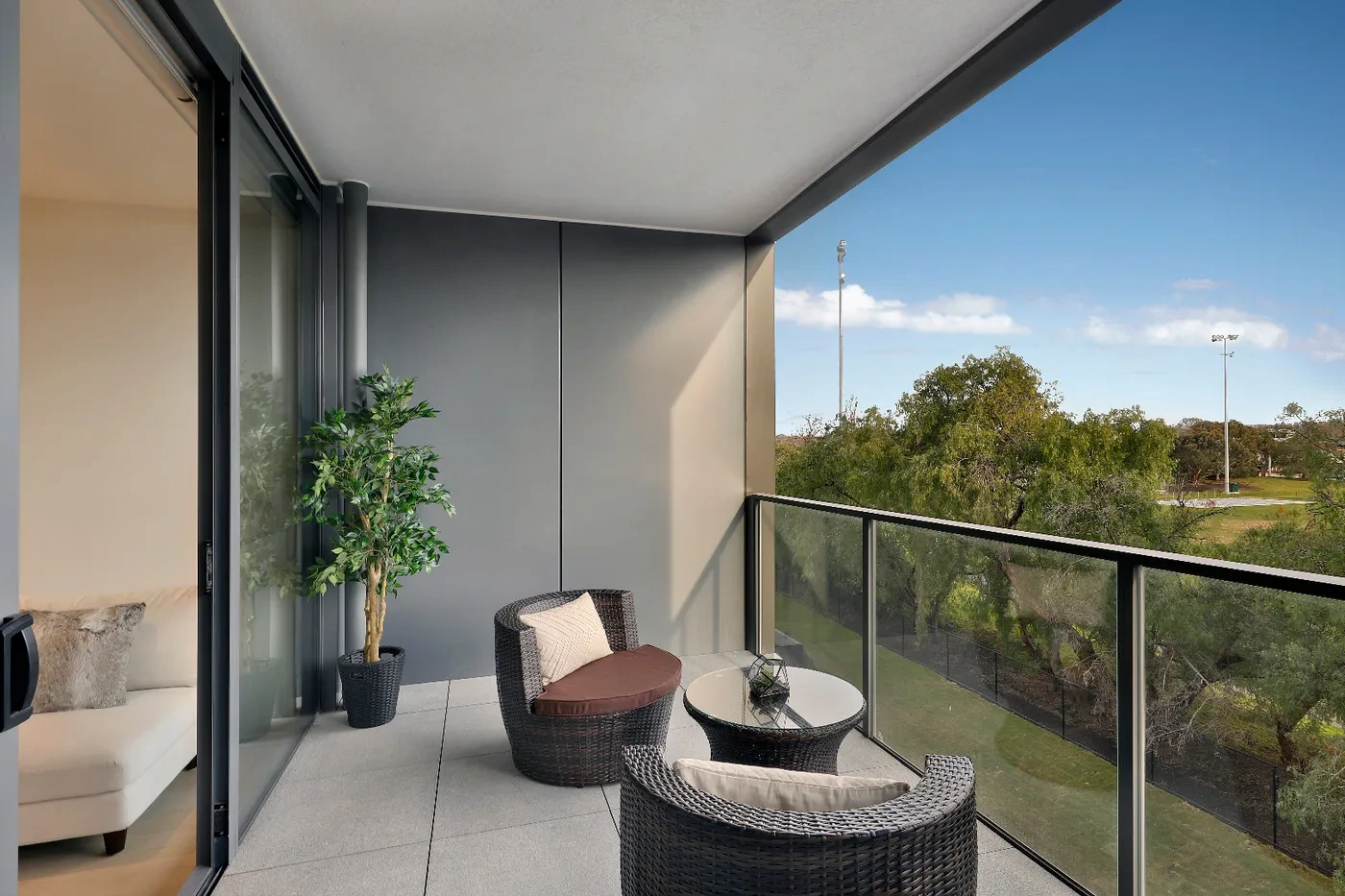 Balcony with a leafy treetop outlook at a Westprecinct serviced residence in Armadale