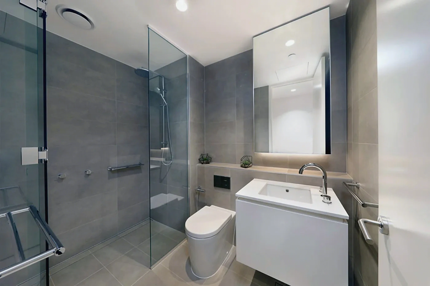 Fully tiled bathroom with walk-in shower in the Armadale residence