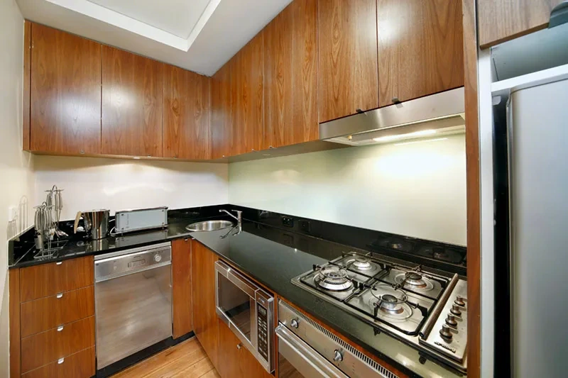 Fully equipped kitchen with stone benchtops and stainless appliances in the Balmain studio