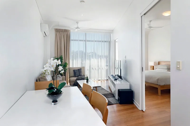 Open-plan living and dining area with balcony outlook in the Balmain residence