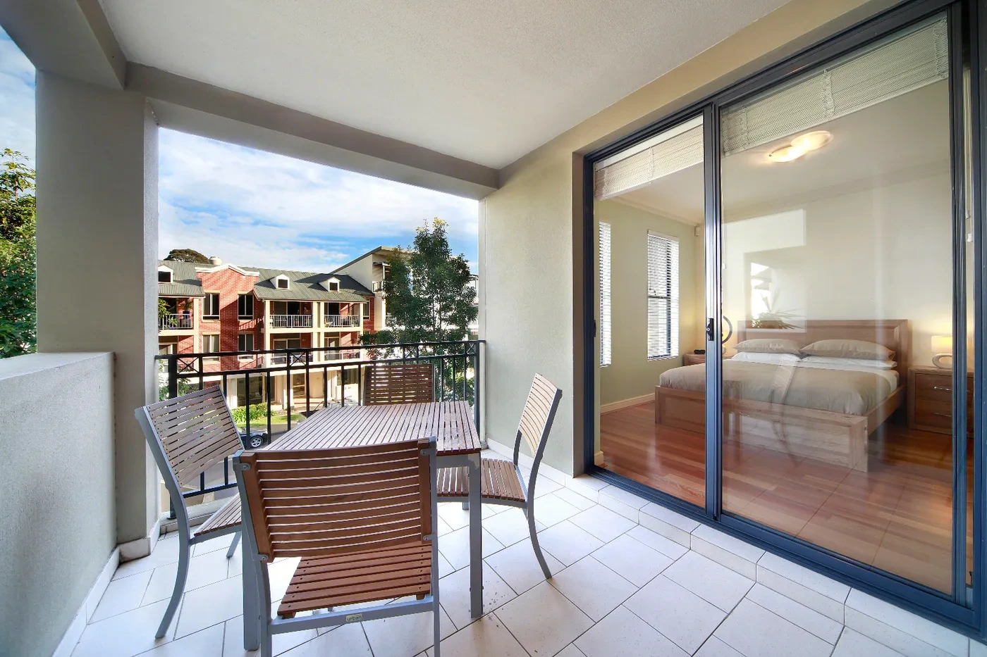 Balcony dining with leafy views at a Westprecinct serviced residence in Balmain