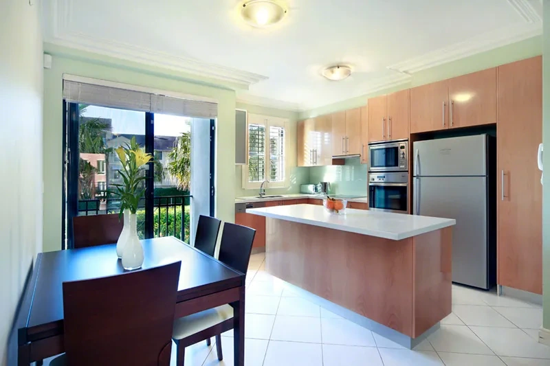 Dining and kitchen with stone benchtops in the Balmain residence