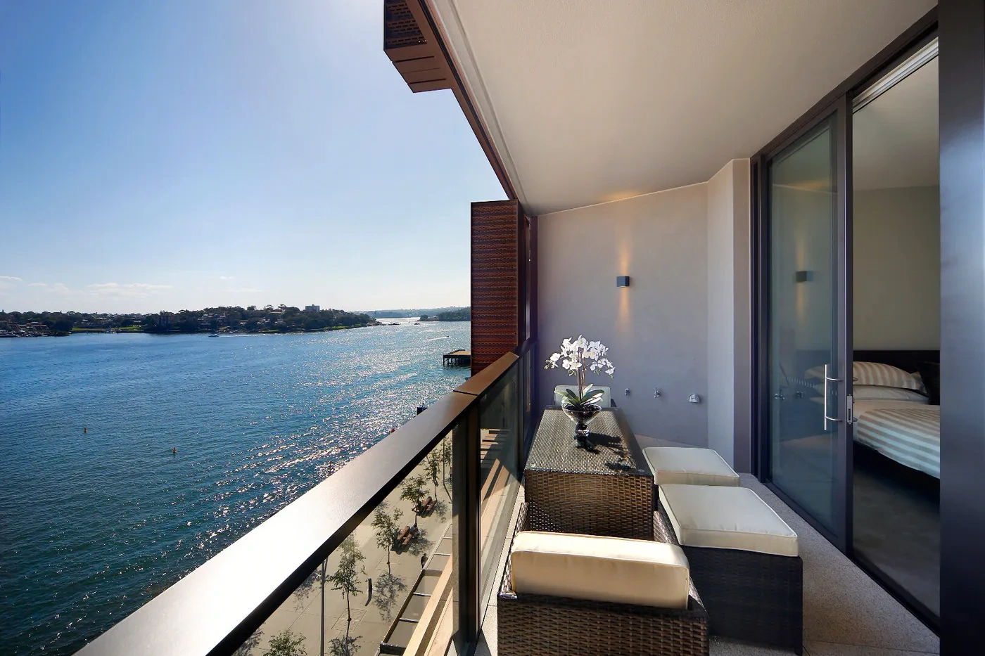 Living room opening to a balcony with Sydney Harbour views at a Westprecinct serviced residence in Barangaroo