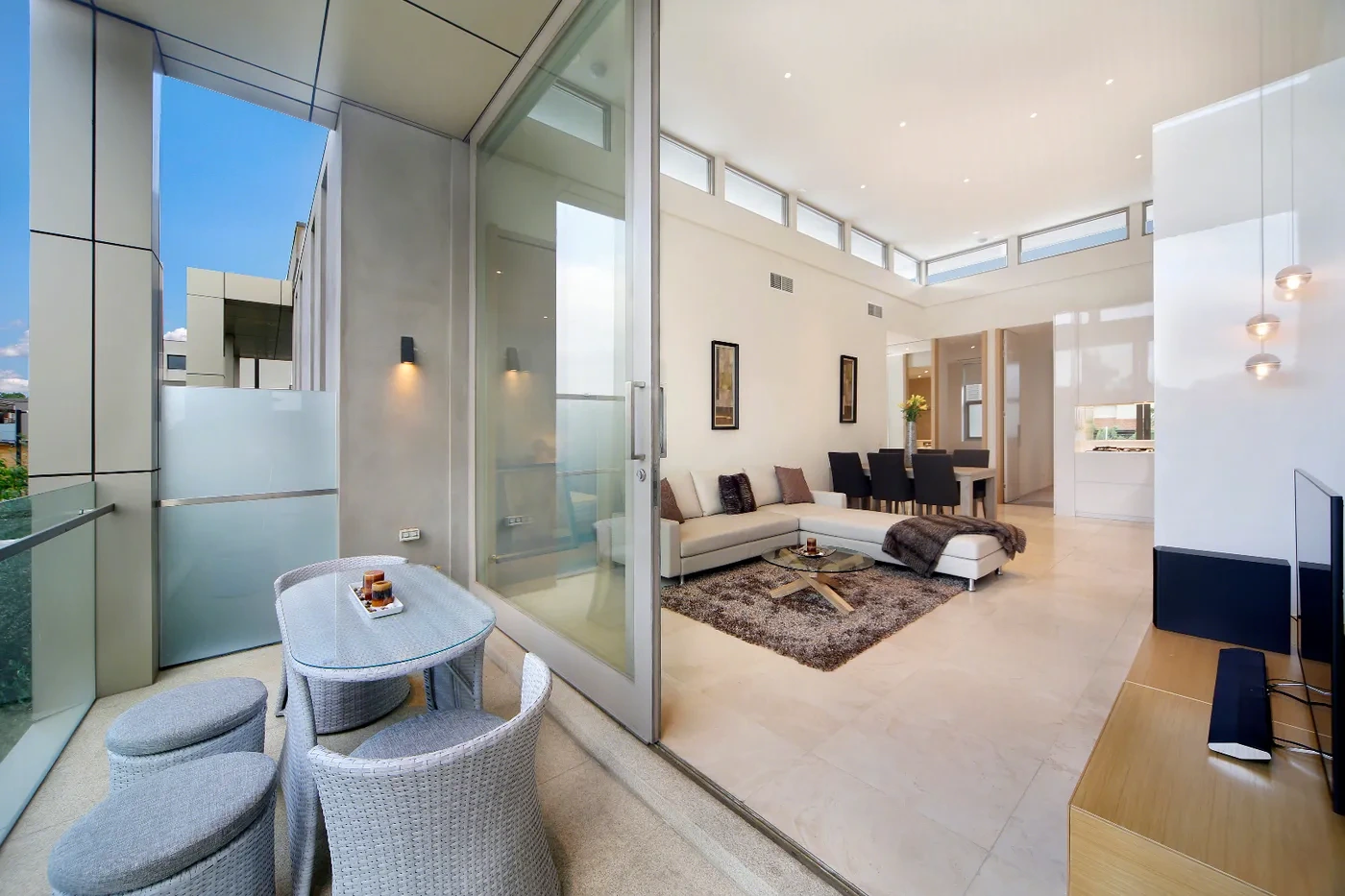 Light-filled living room opening to the balcony at a Westprecinct serviced residence in Brighton