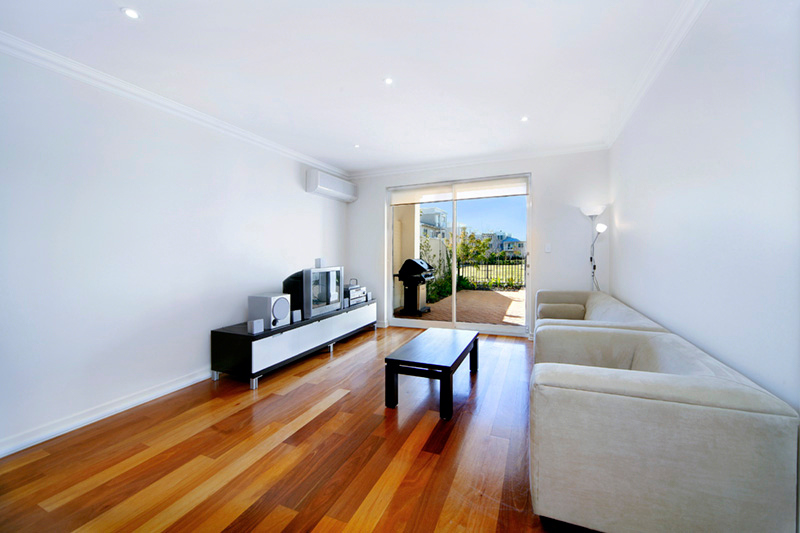 Open-plan living with polished timber floors in Breakfast Point