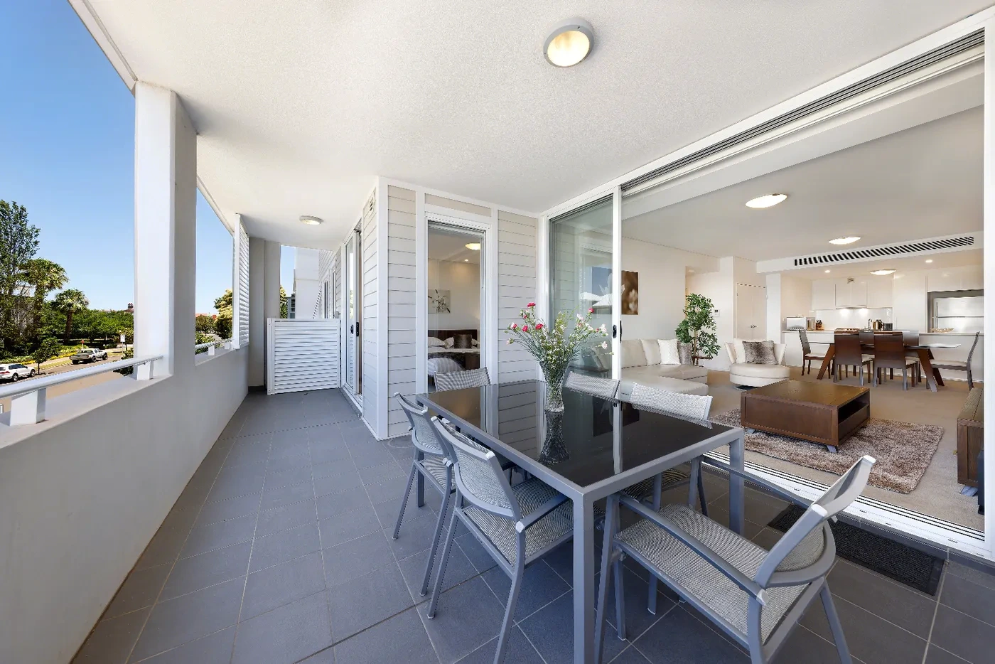 Balcony flowing into the open-plan living room at a Westprecinct serviced residence in Breakfast Point