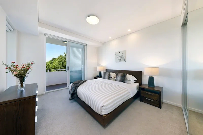 Master bedroom with built-in wardrobes in the high-floor residence