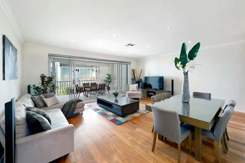 Open-plan living and dining opening to the balcony in Breakfast Point