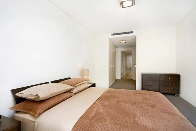 Furnished master bedroom with walk-through to the ensuite