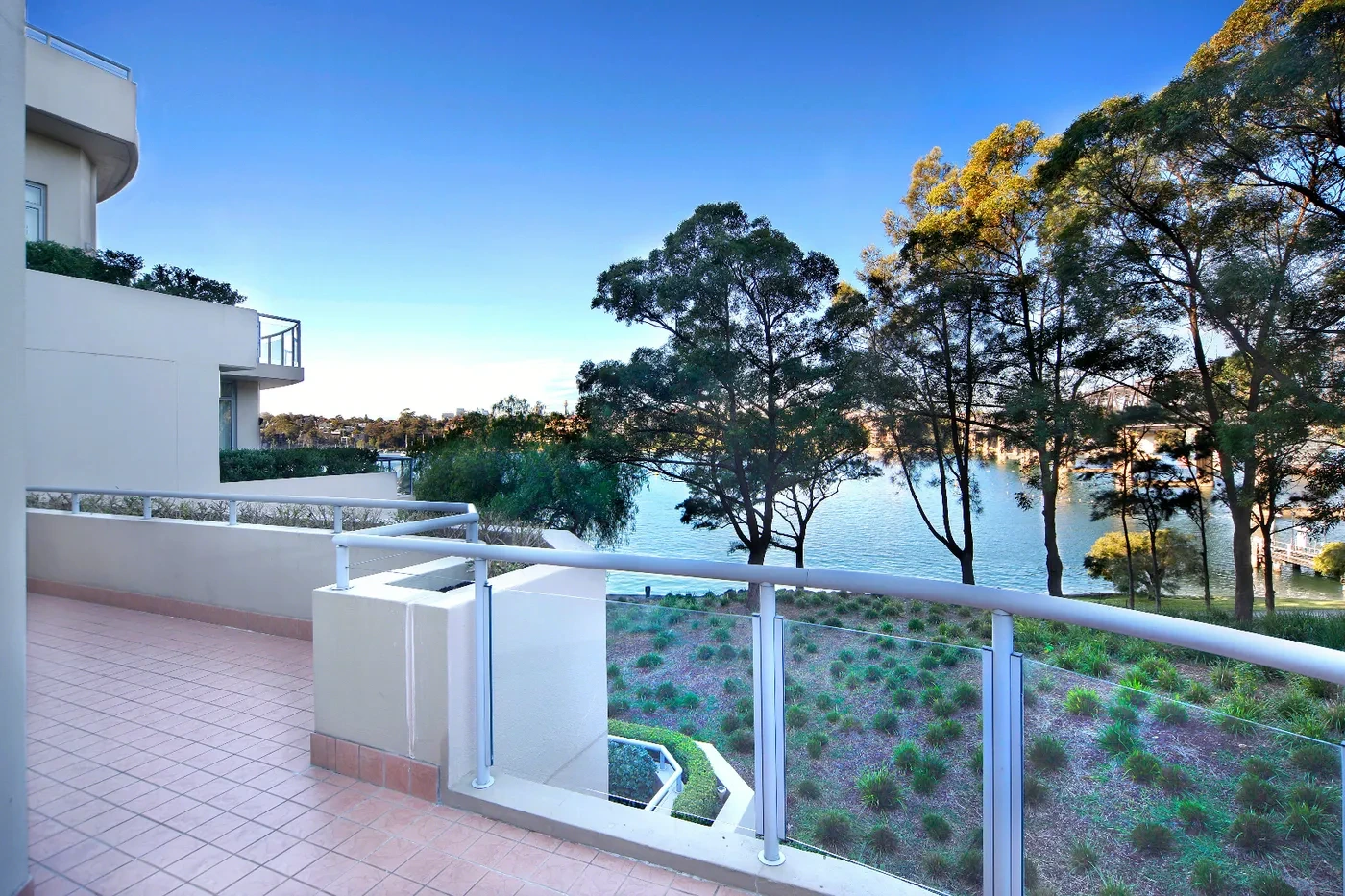 Terrace with harbour and treetop views at a Westprecinct serviced residence in Drummoyne
