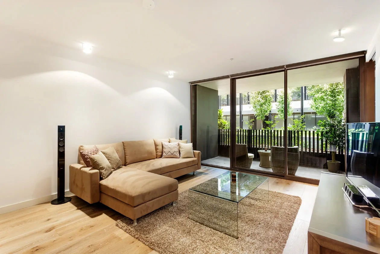 Living room opening to a garden terrace at a Westprecinct serviced residence in Malvern