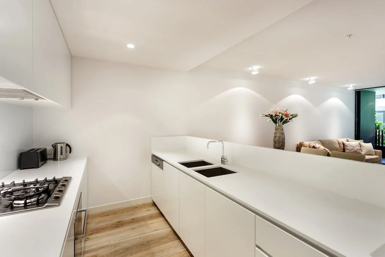 Kitchen opening to the living room at a Westprecinct serviced residence in Malvern
