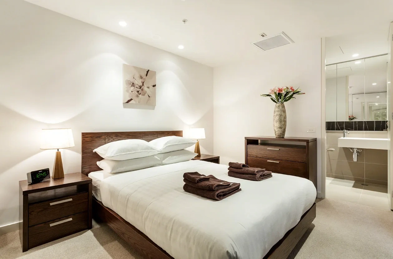 Calm, light-filled main bedroom at a Westprecinct serviced residence in Malvern