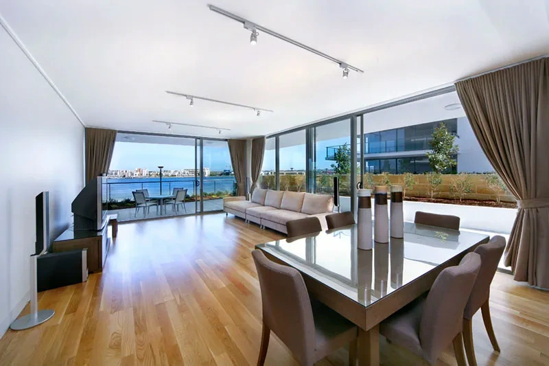 Open-plan living and dining with floor-to-ceiling windows