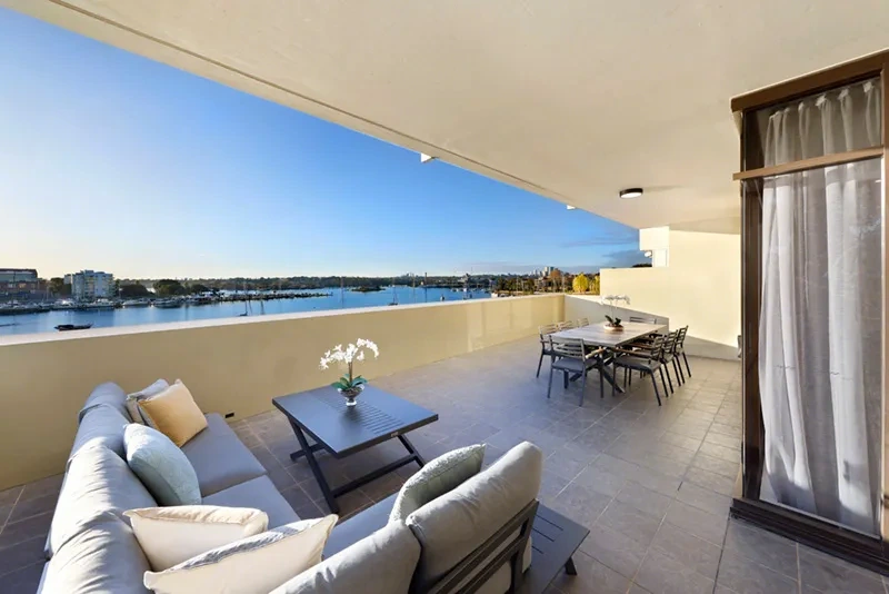 Wrap-around terrace with lounge and alfresco dining overlooking the marina