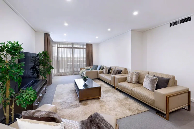Second view of the spacious furnished living area with terrace access