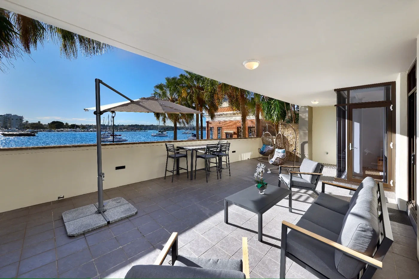 Ground-floor terrace opening off open-plan living in a Rozelle Signature Water X Residence