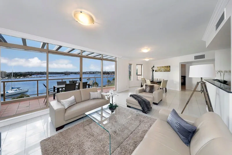 Expansive open-plan living and dining with harbour views