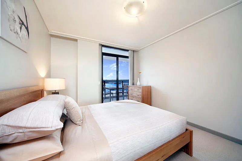 Stylish furnished bedroom with water outlook