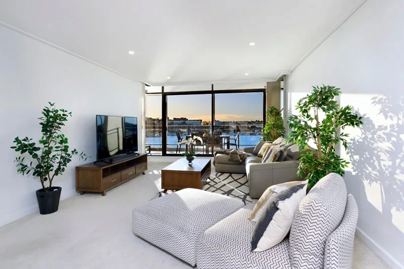 Fresh, modern furnished living area with balcony access