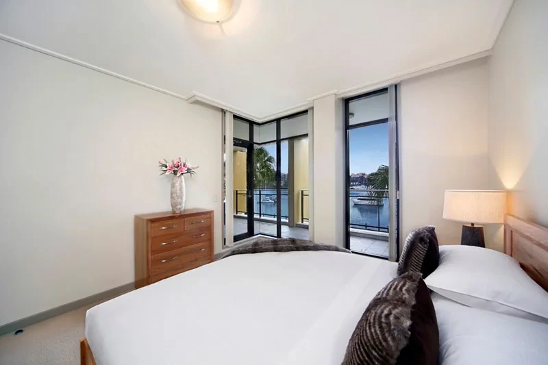 Furnished master bedroom with water outlook