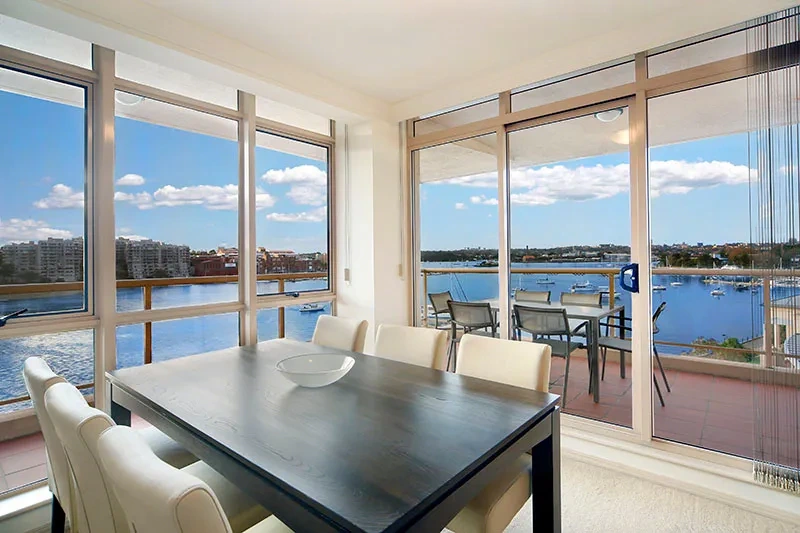 Open-plan dining area with designer furnishings and water outlook