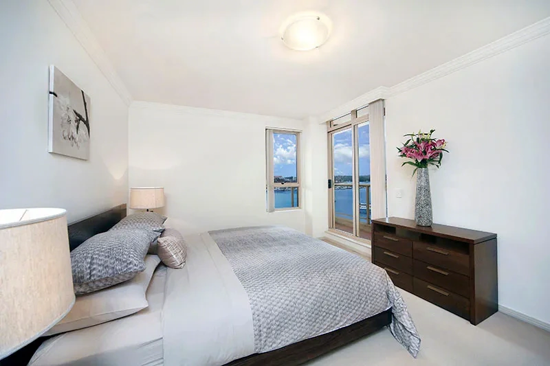 Spacious furnished master bedroom with water outlook